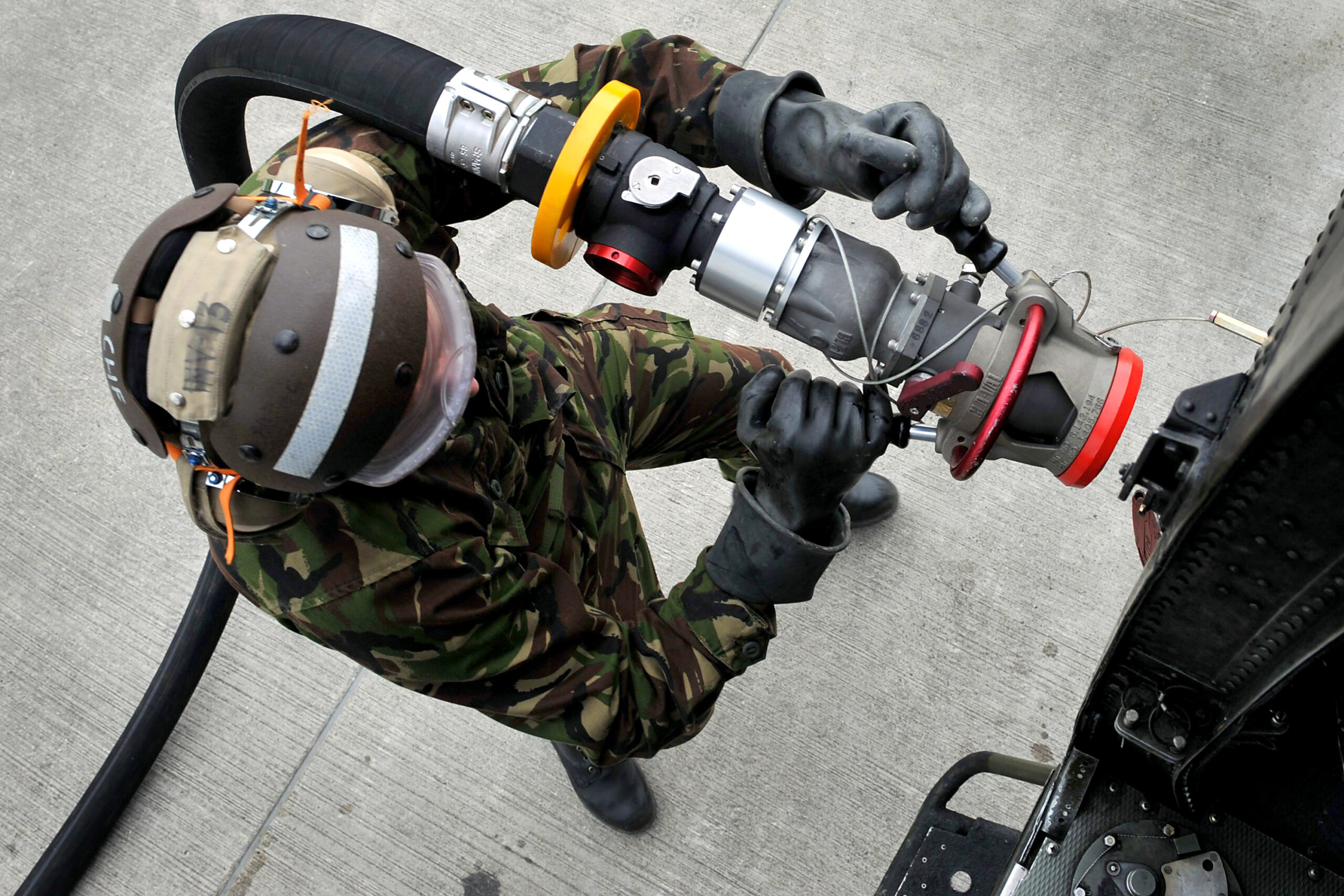 A Royal Navy Mark 4 Sea King 'Jungly' helicopter belonging to 848 Naval Air Squadron (NAS), is refuelled by a technician.

Based at the Royal Naval Air Station (RNAS) Yeovilton, the Commando Helicopter Force enjoys a reputation for high standards of professionalism and flexibility and this is, in no small part, attributable to the exacting and thorough instruction provided by 848 Naval Air Squadron (NAS), or the Jungly Training Academy as it is colloquially known.